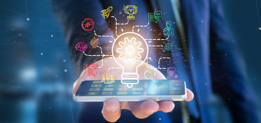Poster - Businessman holding a Bulb lamp idea concept with start up icon connected 3d rendering