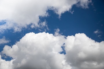 Wall Mural - Beautiful sky background. White fluffy clouds on a deep blue sky background. Scenic sky