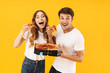 © Drobot Dean - Portrait of caucasian couple man and woman in basic t-shirts smiling while eating pizza from box