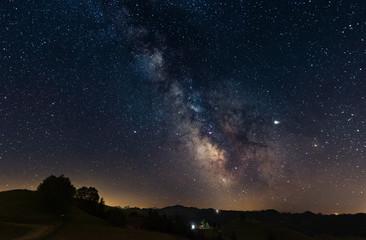 Wall Mural - milky way above hilly landscape in switzerland
