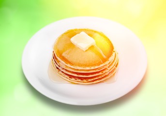 Poster - Stack of Small pancakes in syrup on background