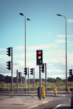 Traffic Lights For Cars On A Road Changing From Red To Green