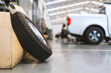 closeup old tire in car repair station with soft-focus and over light in the background