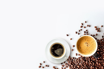 hot espresso and coffee bean on white table with soft-focus and over light in the background. top view