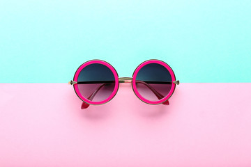 Modern sunglasses on colorful background