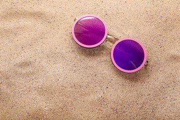 Wall Mural - Modern sunglasses on the beach sand