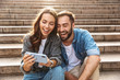 © Drobot Dean - Attractive young couple sitting on stairs outdoors