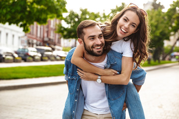 Wall Mural - beautiful young couple in love walking outdoors at the city street