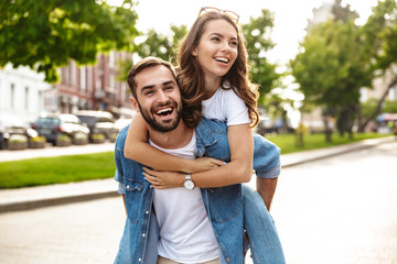 Wall Mural - beautiful young couple in love walking outdoors at the city street