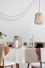 Wall Mural - rattan lamp above table in rustic dining room