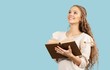 © BillionPhotos.com - Man reading Bible on blue background