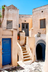 Classic Greek architecture with blue doors and shutters, Santorini, Greece, city of Pyrgos, Europe. Travel concept, details of the one of the most beautiful travel destinations of the world