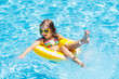 © famveldman - Child in swimming pool on ring toy. Kids swim.