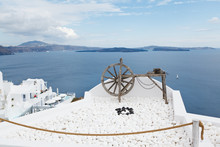 An Old Wooden Spinning Lathe Above Blue Ocean In Santorini
