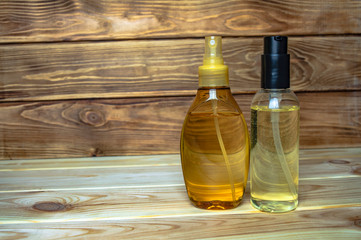 two plastic bottles with massage oil wooden background