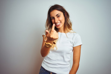 Canvas Print - Young beautiful woman wearing casual white t-shirt over isolated background Beckoning come here gesture with hand inviting welcoming happy and smiling