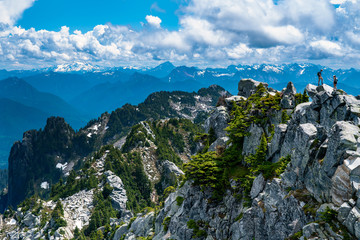 mountain peak with hikers visible in distance