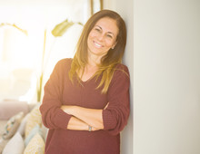 Beautiful Middle Age Woman Smiling With Crossed Arms At Home