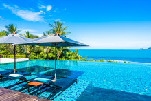 Beautiful Luxury Outdoor Swimming Pool In Hotel Resort With Sea Ocean Around Coconut Palm Tree And White Cloud On Blue Sky