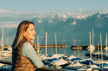 Outdoor Fashion Portrait Of Beautiful Young Woman Posing By The Lake In A Small Port