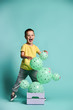 © FAB.1 - Cheerful little child boy and green cactus-shaped balloons in a box. Raffle