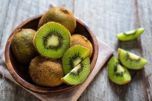 Fresh kiwi fruit in the bowl on wooden background Tableau sur Toile
