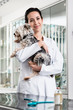© Kzenon - Smiling veterinarian carrying sick puppy