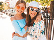 © halayalex - Two young beautiful smiling hipster girls in trendy summer clothes and panama hat. Sexy carefree women posing on street background.Positive models having fun in sunglasses.Hugging