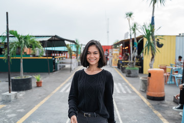 Wall Mural - Portrait of asian young woman smiling look happy walking on the way