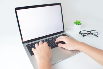 Poster - Hands use a laptop computer as a white screen on a modern white table.