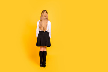 Poster - Rear back behind full length body size view of her she nice-looking attractive straight-haired pre-teen girl standing still isolated on bright vivid shine yellow background