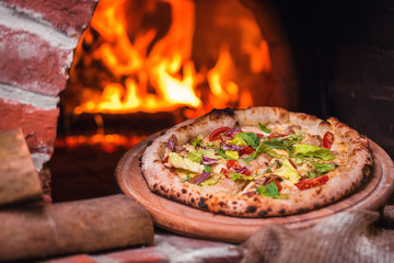 Wall Mural - tasty pizza out of oven in restaurant kitchen