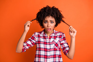 Poster - Close-up portrait of her she nice attractive frustrated depressed wavy-haired lady holding weak thin messy curls anti lose loss solution isolated on bright vivid shine orange background