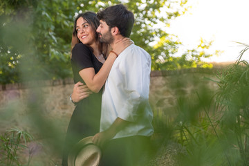 Portrait of a young couple in love enjoying in a city park