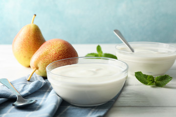 Wall Mural - Composition with cream yogurts and fruits on white table, space for text