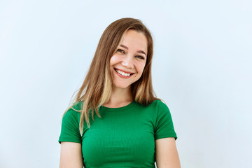 Wall Mural - Young girl  portrait against white background. Laughter and joy emotions