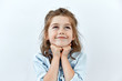 Dreamy,pleased, thinking emotion . Wish concept. Little child girl face portrait on white backgound.