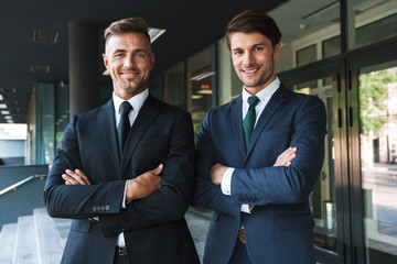 Canvas Print - Portrait closeup of two successful businessmen partners smiling while standing outside job center during working meeting