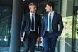 © Drobot Dean - Portrait of two serious businessmen partners having conversation outside job center during working meeting