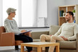 © Syda Productions - psychology, mental therapy and people concept - smiling senior woman psychologist with clipboard talking to young man patient at psychotherapy session