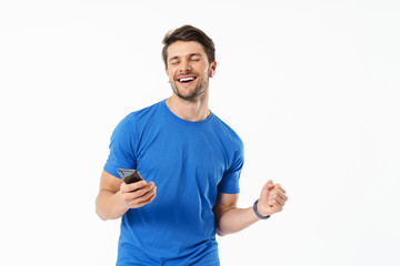 Poster - Photo closeup of happy man in casual t-shirt smiling and holding smartphone while wearing wireless earpods