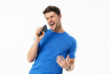 Poster - Photo closeup of joyful man in casual t-shirt singing and holding smartphone while wearing wireless earpods