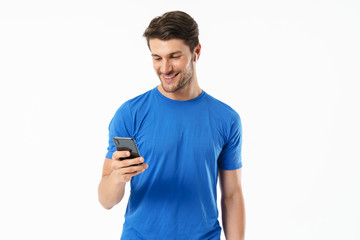 Poster - Photo closeup of masculine man in casual t-shirt smiling and holding smartphone while wearing wireless earpods