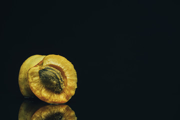 Poster - Beautiful fresh apricot on a black glass table background.
