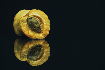 Poster - Beautiful fresh apricot on a black glass table background.