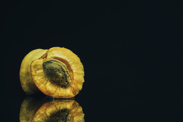 Poster - Beautiful fresh apricot on a black glass table background.