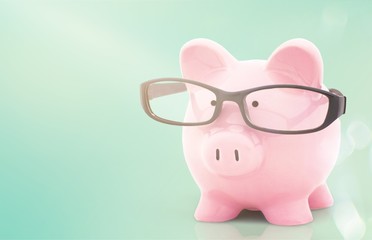  Piggy bank in glasses on background