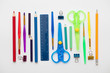 Row of colourful art supplies arranged in a rainbow