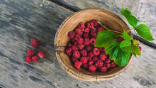 Organic Fresh Raspberries In A Wooden Bowl On Old Wooden Table Background. Rustic Style.