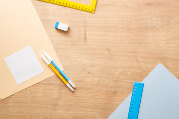 Modern school supplies on wooden desk table background. Back to school concept. Flat lay, top view.
